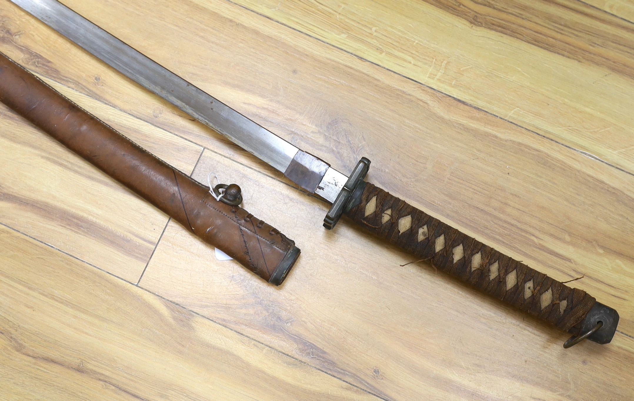 A Japanese WWII Shin gunto (sword) and leather mounted scabbard